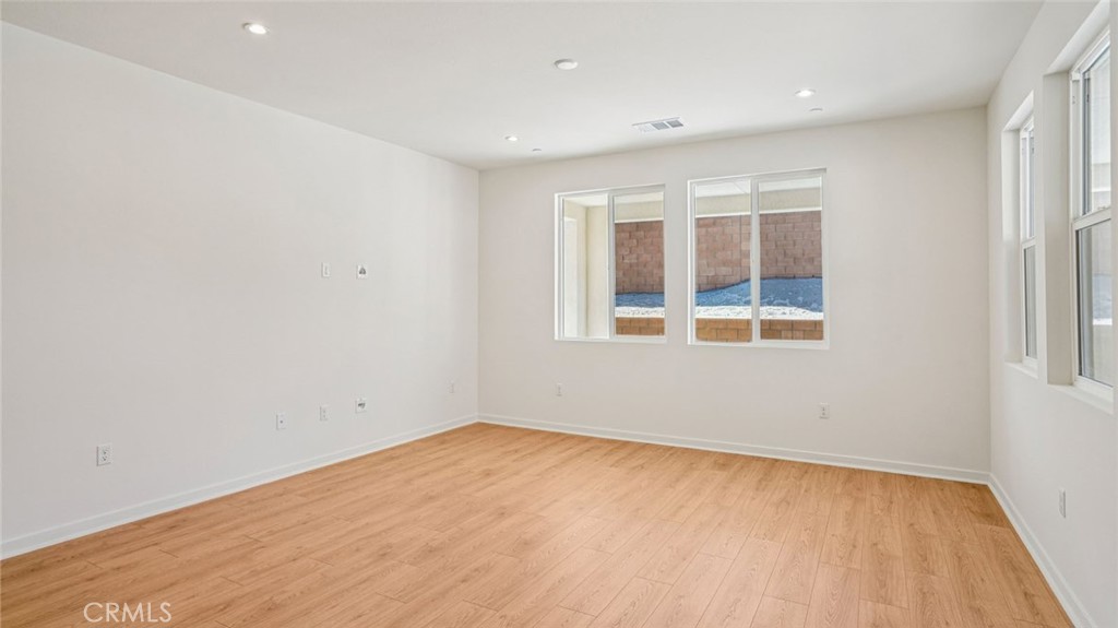 73578 Raphael Drive Palm Desert, CA 92211 - Photo 5 of 33 a view of empty room with wooden floor and fan