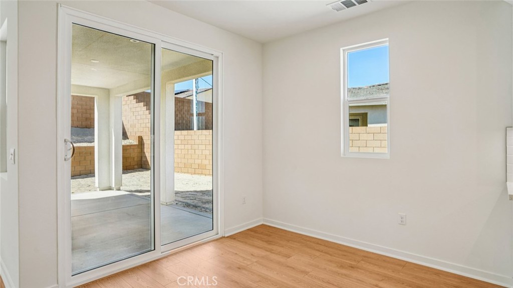 73578 Raphael Drive Palm Desert, CA 92211 - Photo 7 of 33 a view of an empty room with wooden floor and a window