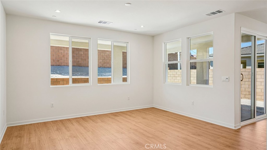 73578 Raphael Drive Palm Desert, CA 92211 - Photo 8 of 33 an empty room with wooden floor and windows