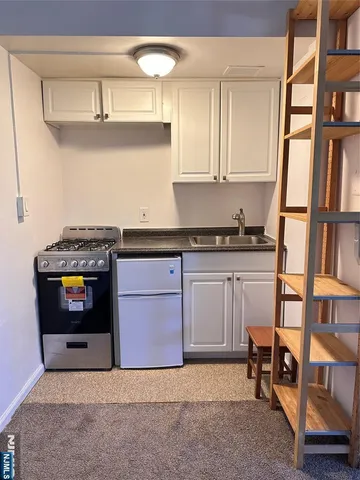 a kitchen with a stove and a cabinet