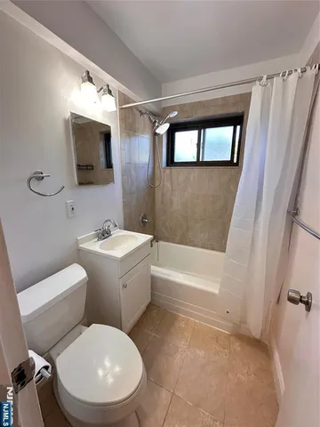 a white toilet sitting next to a bathroom sink and tub
