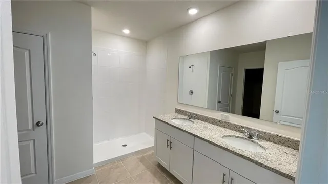 a bathroom with a glass shower door