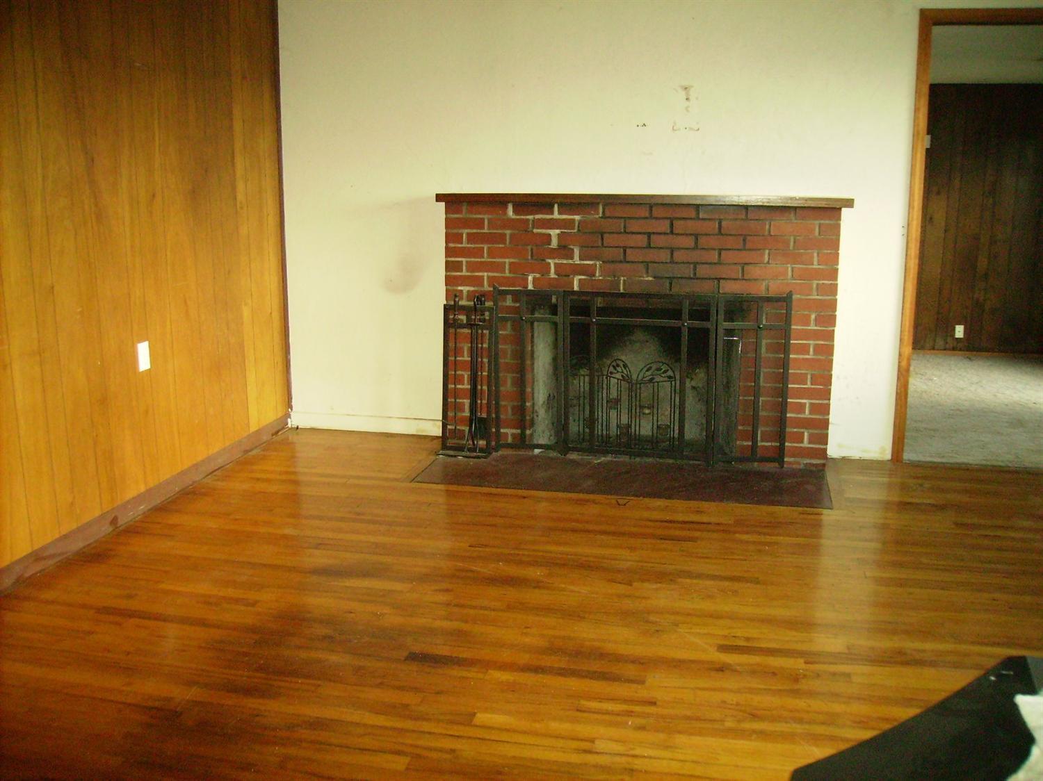 404 Bigham Brown Road Eagle Point, OR 97524 - Photo 4 of 17 a view of empty room with wooden floor and a fireplace