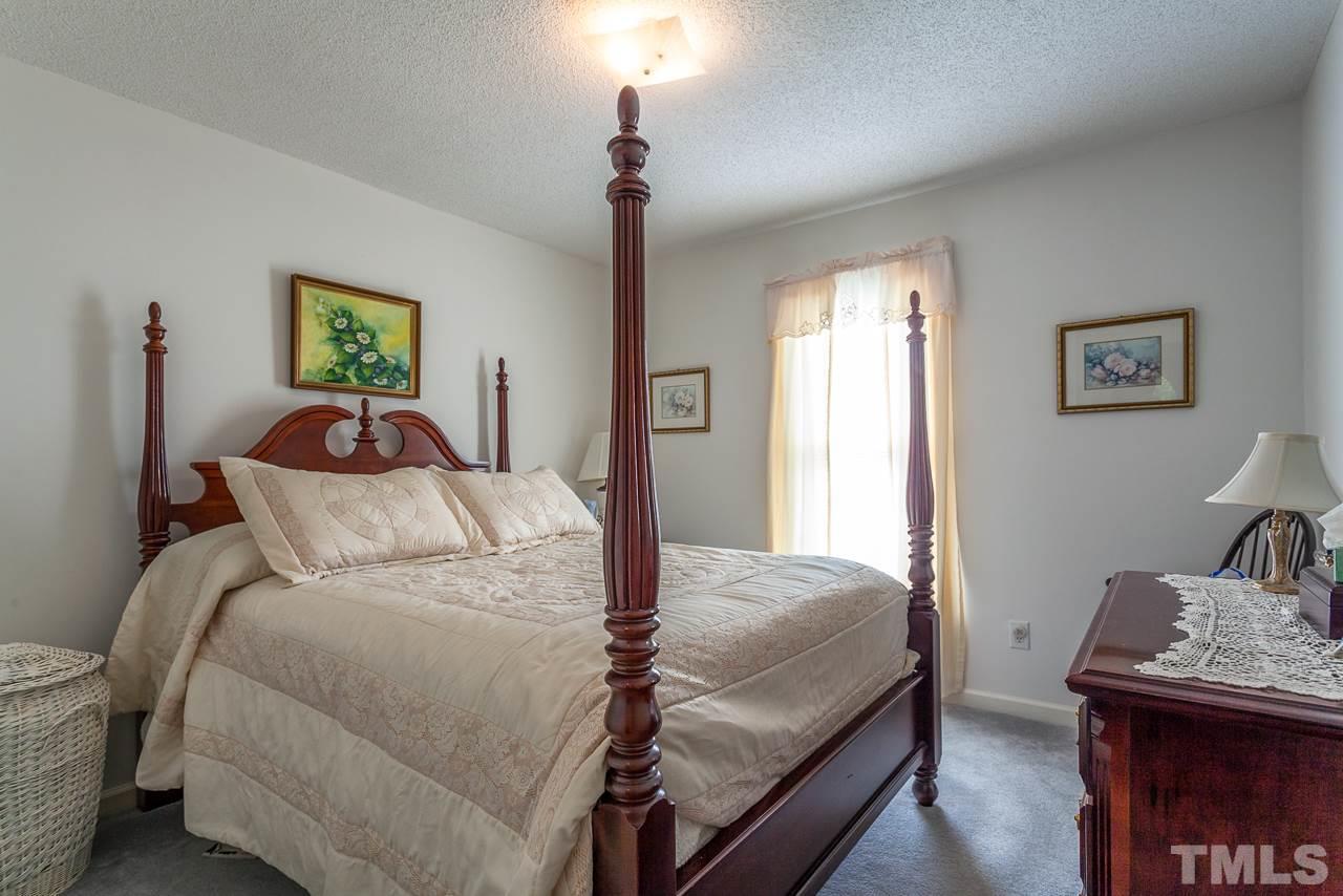 5110 Raleigh Road Benson, NC 27504 - Photo 14 of 24 a bedroom with a bed and a table