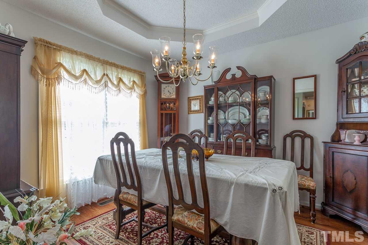 5110 Raleigh Road Benson, NC 27504 - Photo 3 of 24 a view of a dining room with furniture window and wooden floor