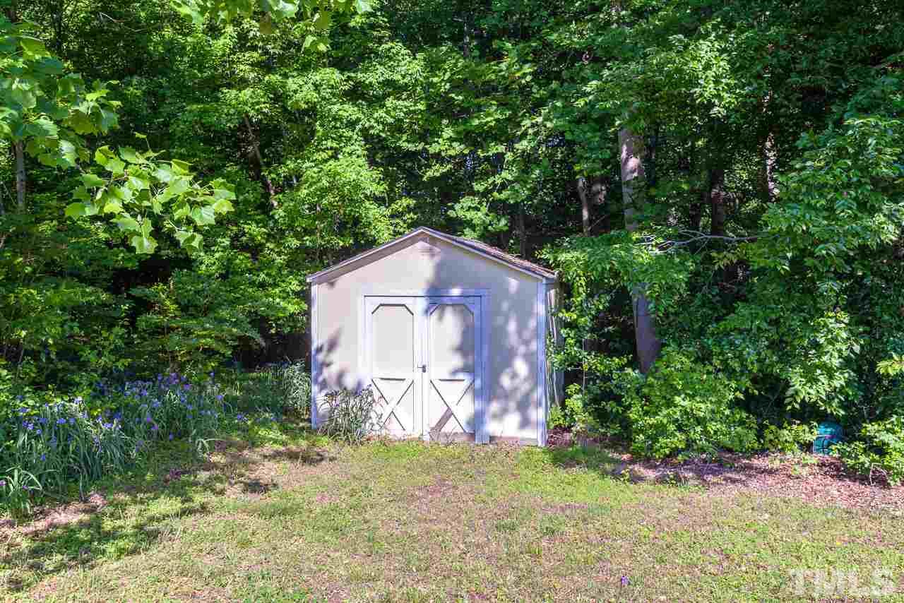 5110 Raleigh Road Benson, NC 27504 - Photo 22 of 24 a house with trees in front of it