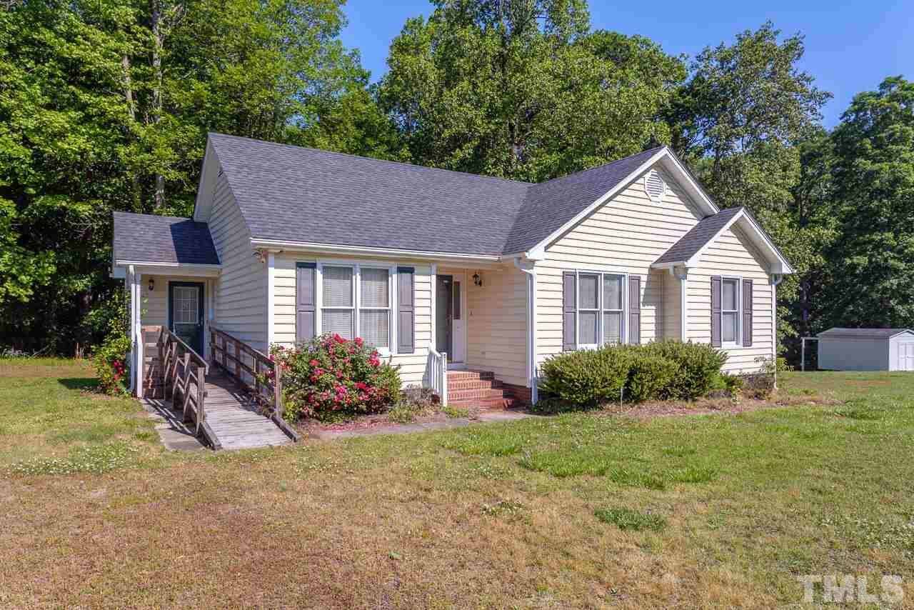 5110 Raleigh Road Benson, NC 27504 - Photo 23 of 24 a front view of a house with yard and green space