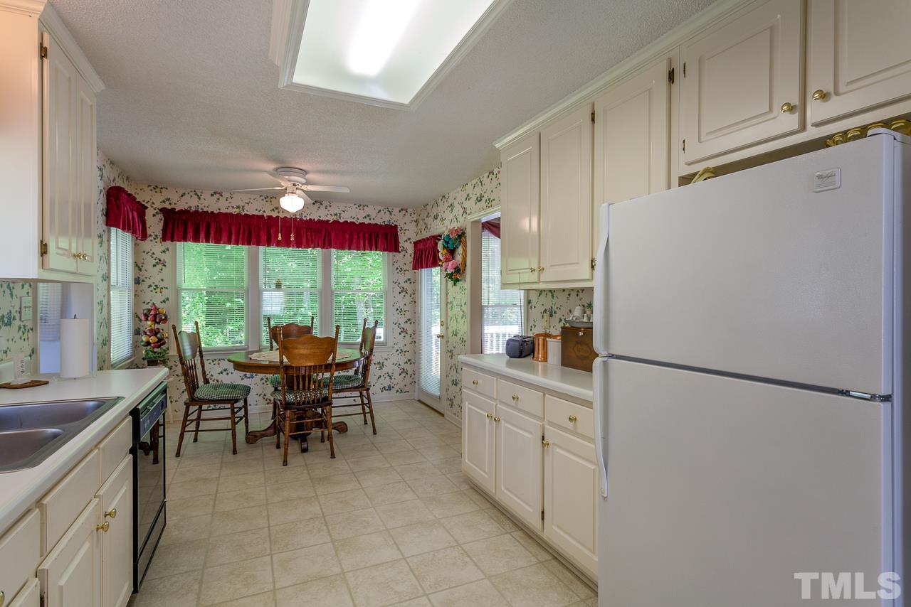 5110 Raleigh Road Benson, NC 27504 - Photo 5 of 24 a kitchen with refrigerator cabinets table and chairs