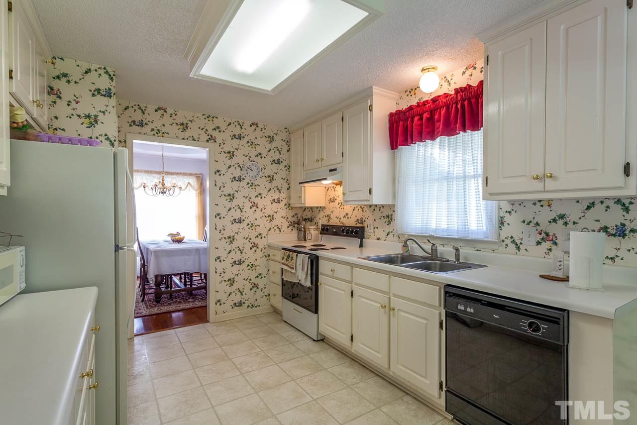 5110 Raleigh Road Benson, NC 27504 - Photo 7 of 24 a kitchen with stainless steel appliances granite countertop a sink dishwasher and a refrigerator
