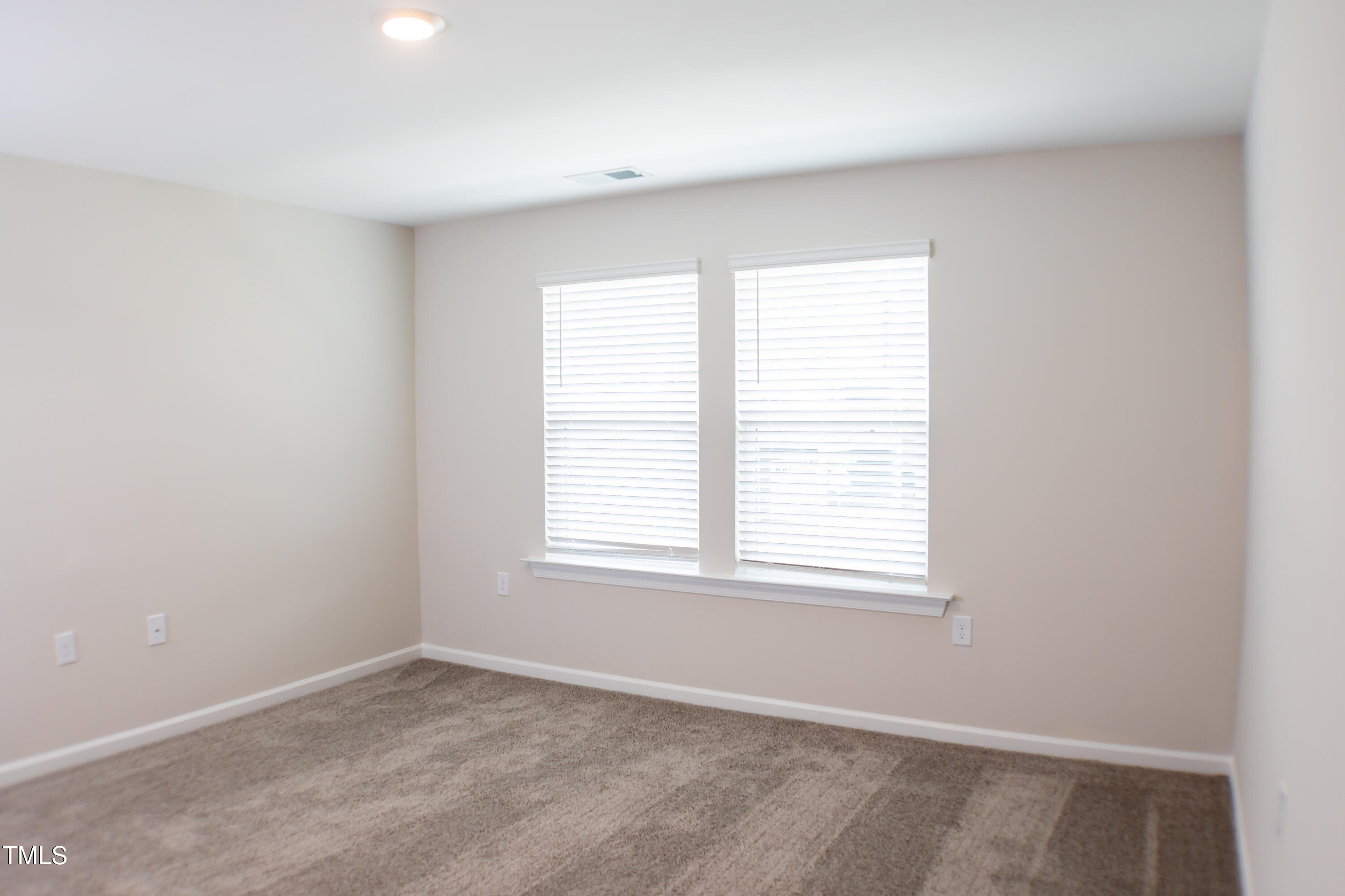 856 Patriot Summit Lane Apex, NC 27523 - Photo 12 of 25 an empty room with a window