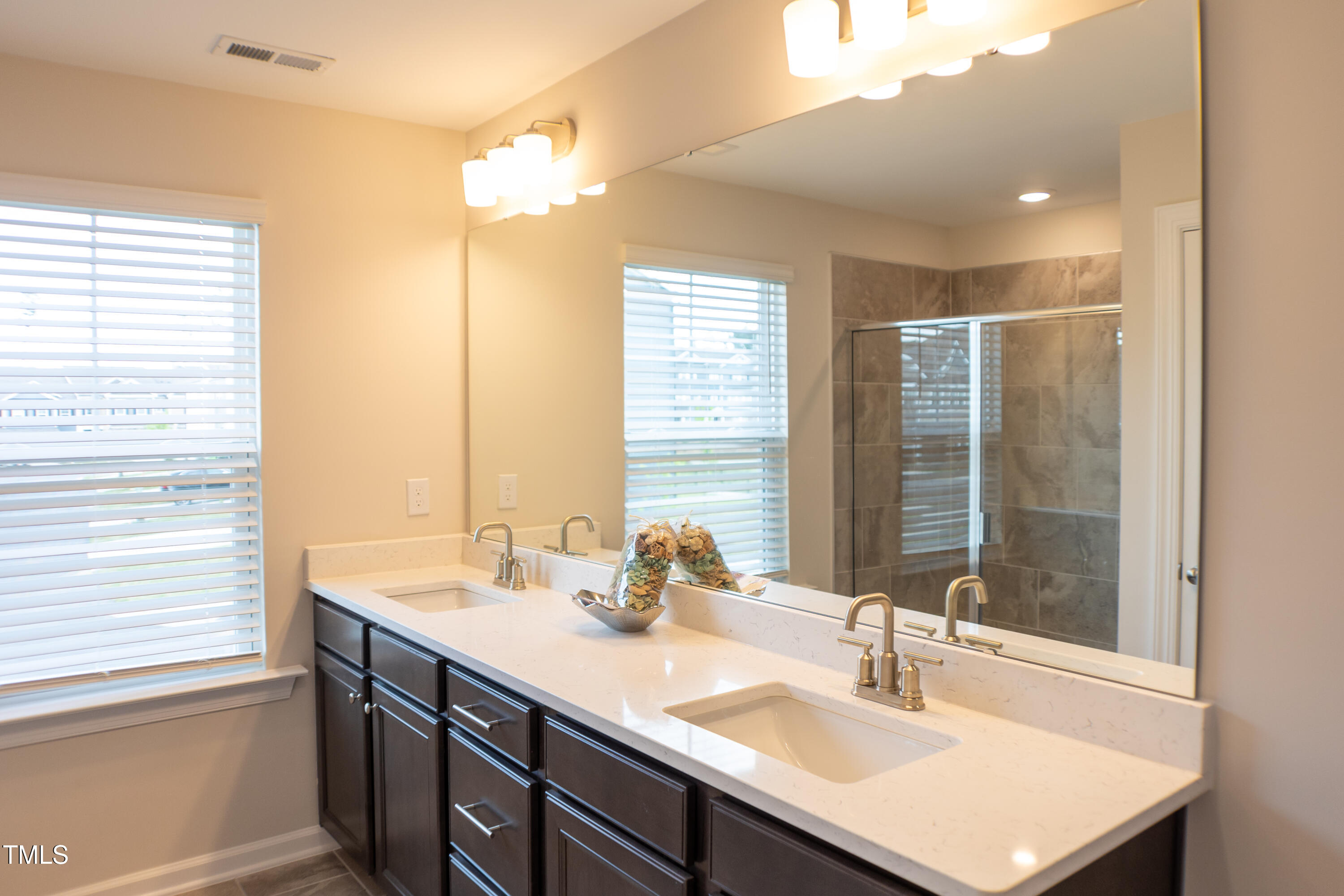 856 Patriot Summit Lane Apex, NC 27523 - Photo 15 of 25 a bathroom with a sink double vanity and a mirror