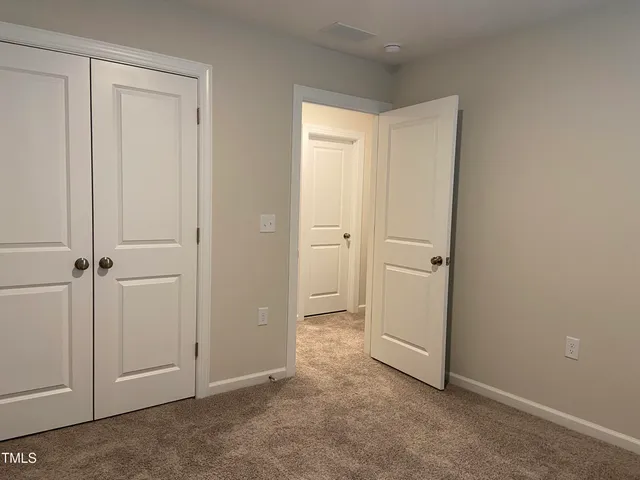 an empty room with closet area