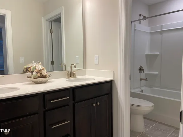 a bathroom with a granite countertop sink toilet a shower and a bathtub