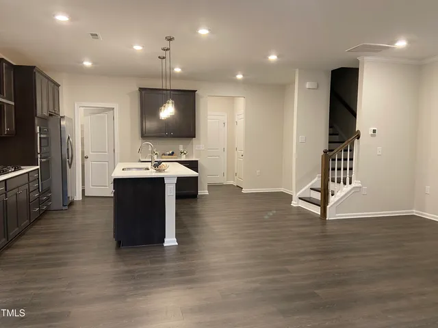 a room with wooden floor and furniture