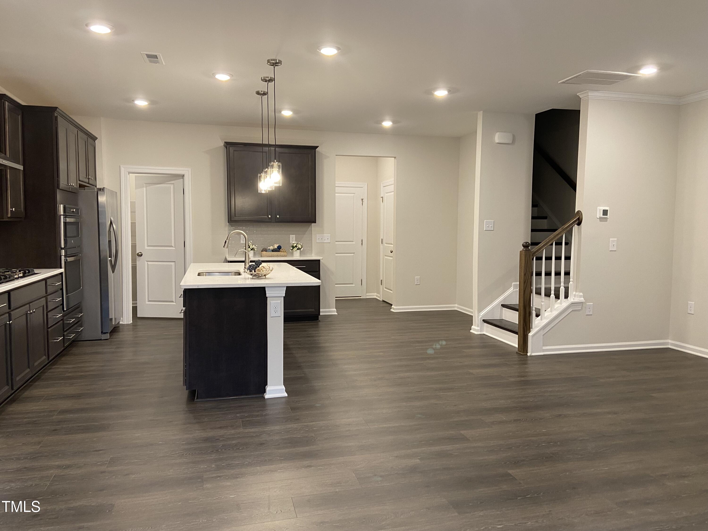 856 Patriot Summit Lane Apex, NC 27523 - Photo 3 of 25 a room with wooden floor and furniture