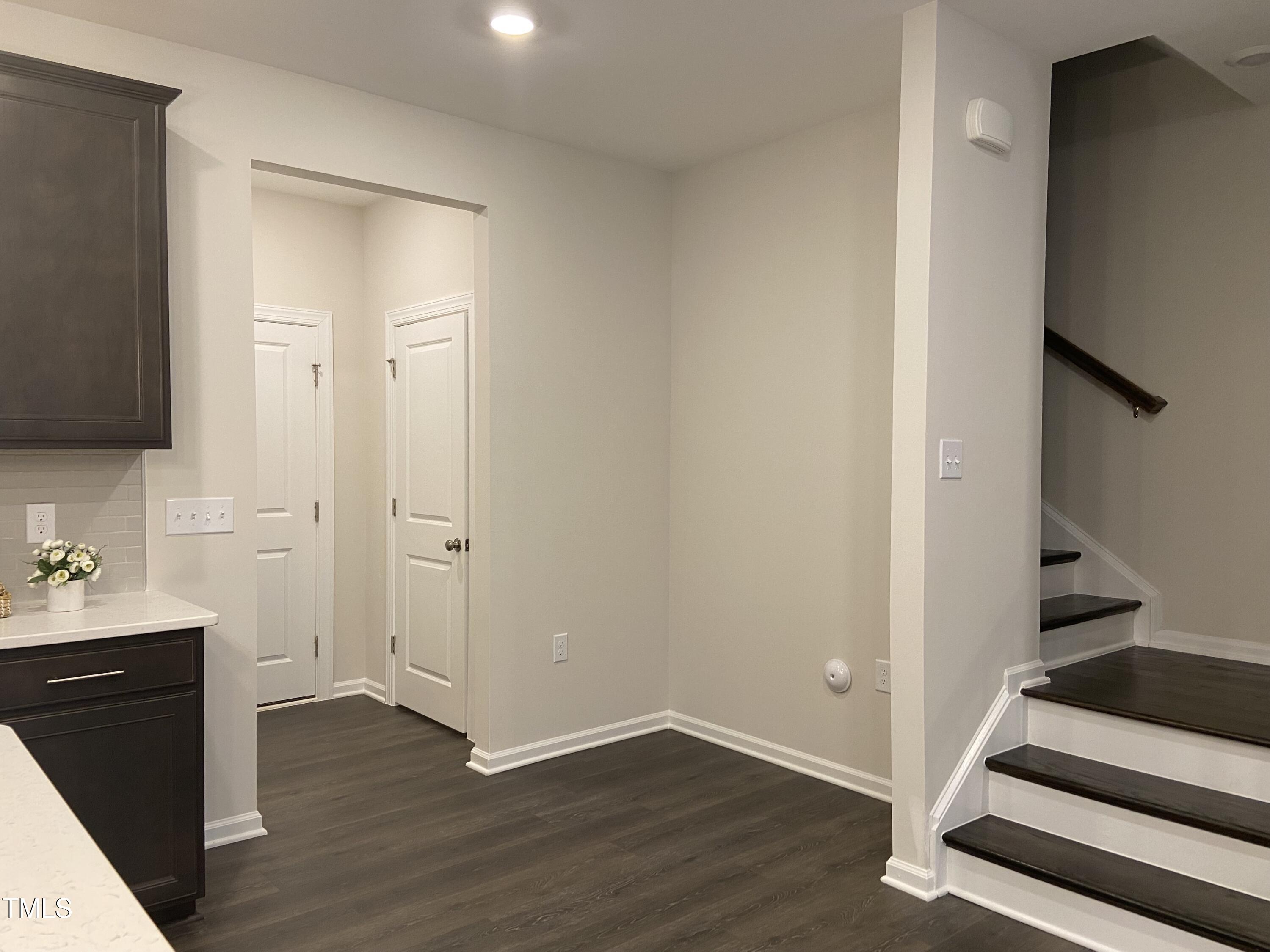 856 Patriot Summit Lane Apex, NC 27523 - Photo 8 of 25 a view of a hallway with wooden floor and bathroom