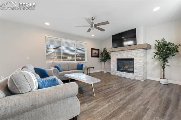 a living room with furniture and a fireplace