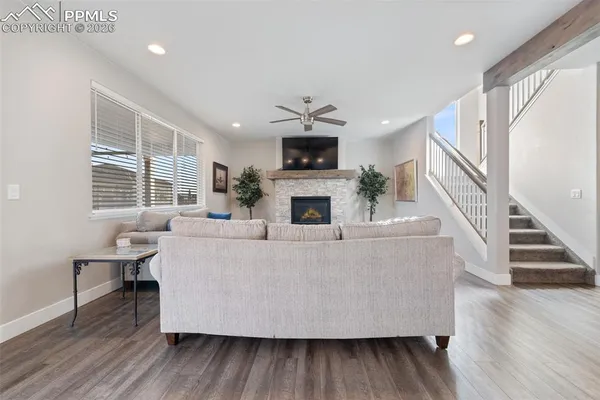 a living room with furniture a fireplace and a flat screen tv