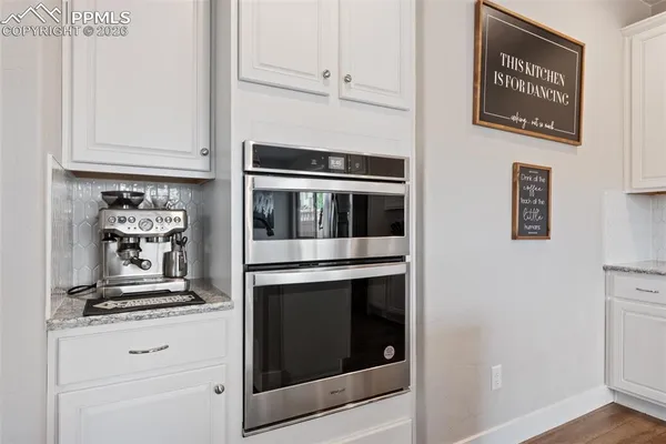 a kitchen with stainless steel appliances granite countertop a stove and a microwave