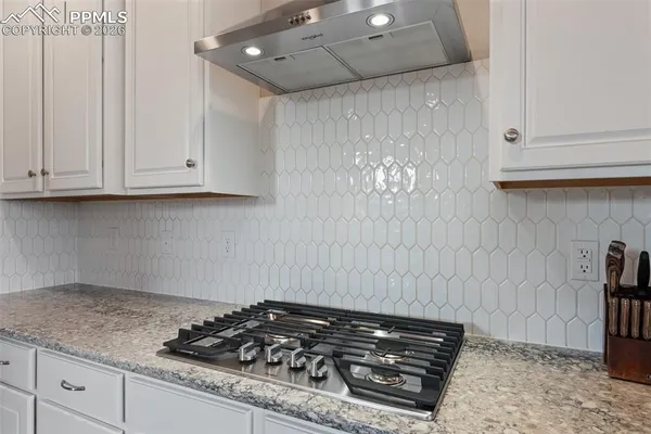 a stove top oven sitting inside of a kitchen