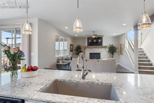a kitchen with sink refrigerator and microwave