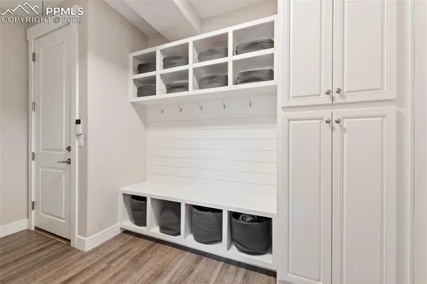 a kitchen with stainless steel appliances granite countertop a sink a stove and a wooden floors