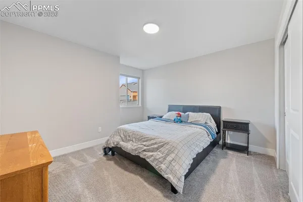 a bedroom with a bed and a night stand