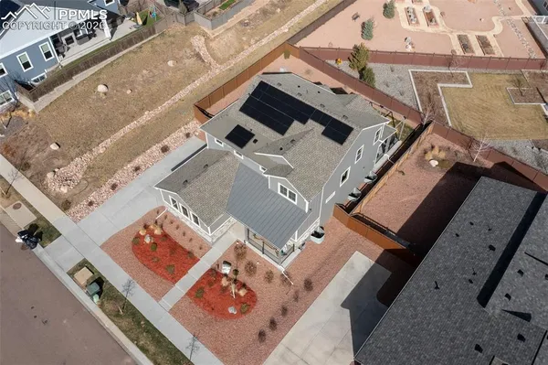an aerial view of a house with a big yard