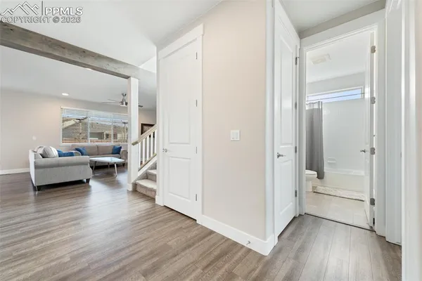 a view of a livingroom with furniture and hardwood floor
