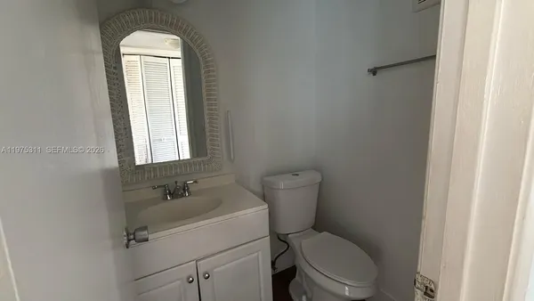 a white toilet sitting next to a bathroom sink
