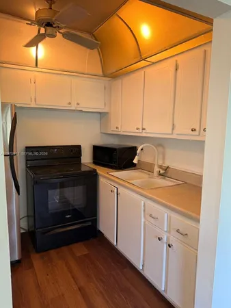 a kitchen with sink cabinets and stainless steel appliances