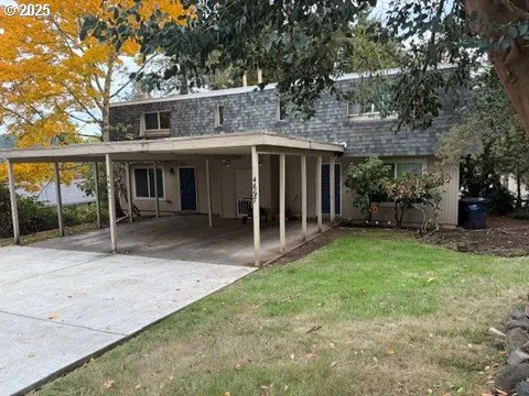 a view of a house with backyard porch and sitting area