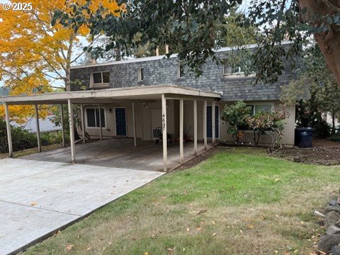 a view of a house with backyard porch and sitting area