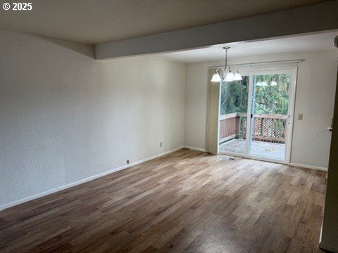 4695 Fox Hollow Road Eugene, OR 97405 - Photo 2 of 9 a view of an empty room with wooden floor and a window