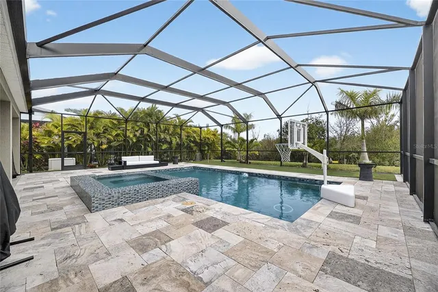 a view of a dining room with furniture a chandelier and a window