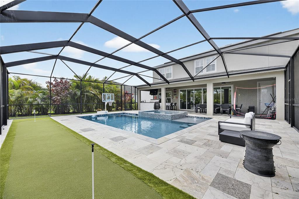 7424 Paradiso Drive Apollo Beach, FL 33572 - Photo 15 of 99 a view of a patio with a table and chairs under an umbrella