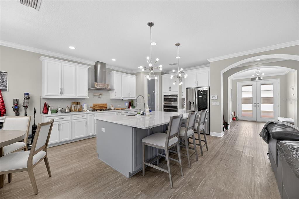 7424 Paradiso Drive Apollo Beach, FL 33572 - Photo 41 of 99 a kitchen with stainless steel appliances a dining table chairs stove and cabinets