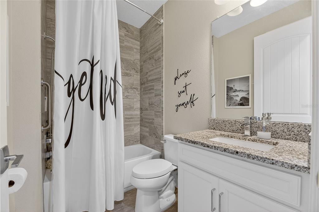 7424 Paradiso Drive Apollo Beach, FL 33572 - Photo 52 of 99 a bathroom with a granite countertop sink toilet and shower