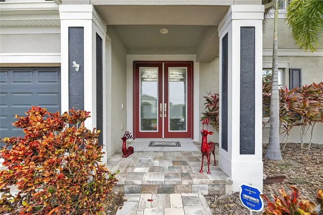 a view of a patio with a table and chairs under an umbrella