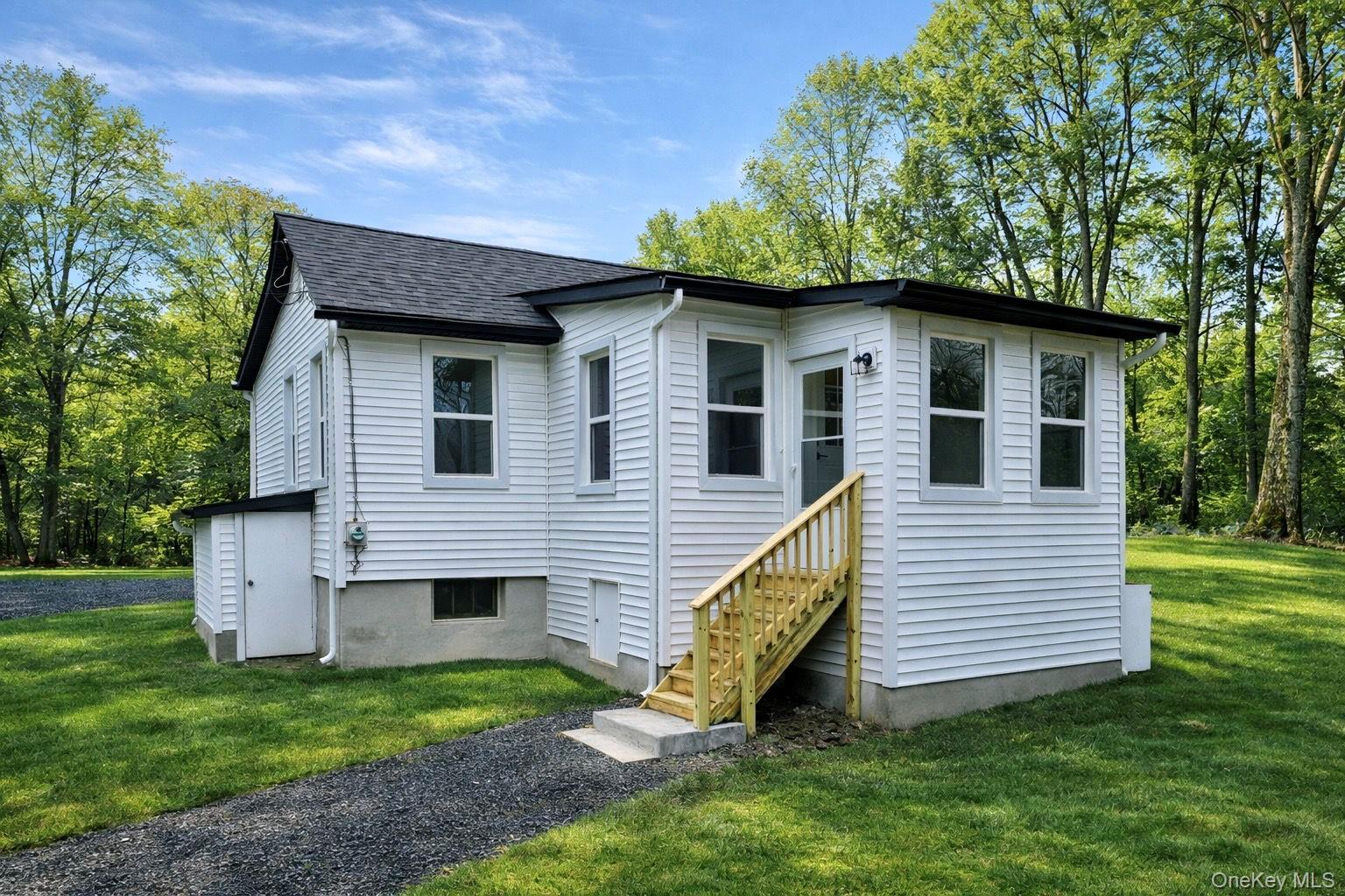 house with a yard and roof with shingles