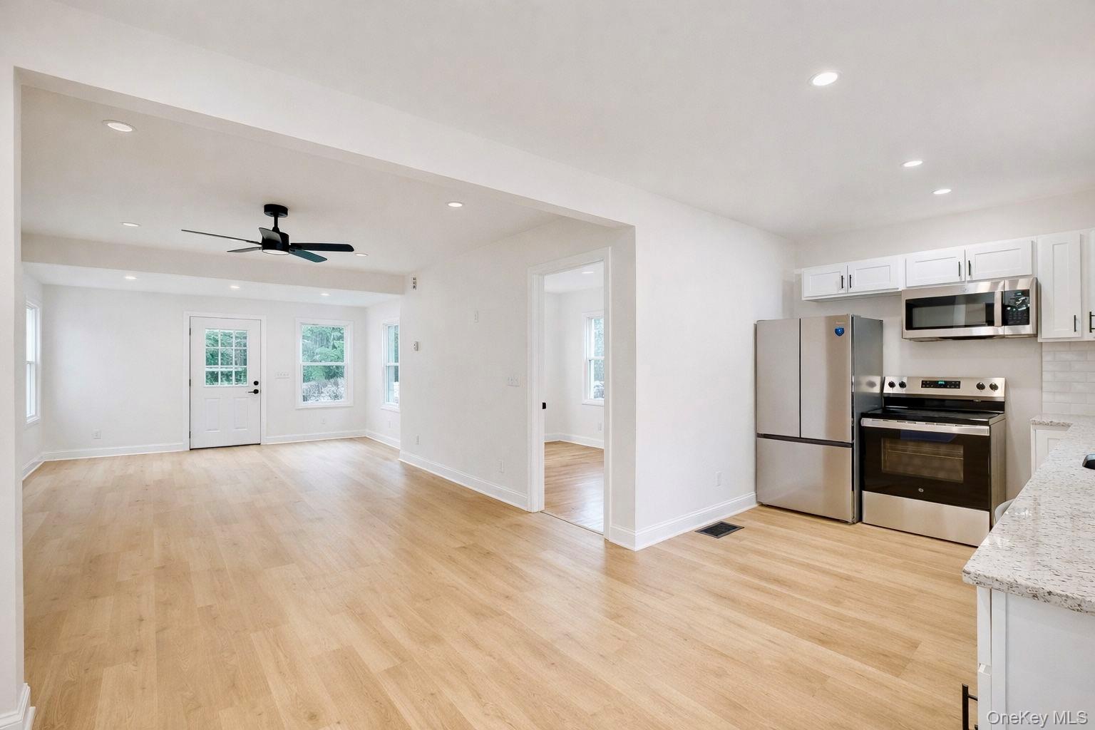 548 Dosen Road Middletown, NY 10940 - Photo 18 of 41 Kitchen featuring stainless steel appliances, white cabinets, recessed lighting, light wood finished floors, and ceiling fan