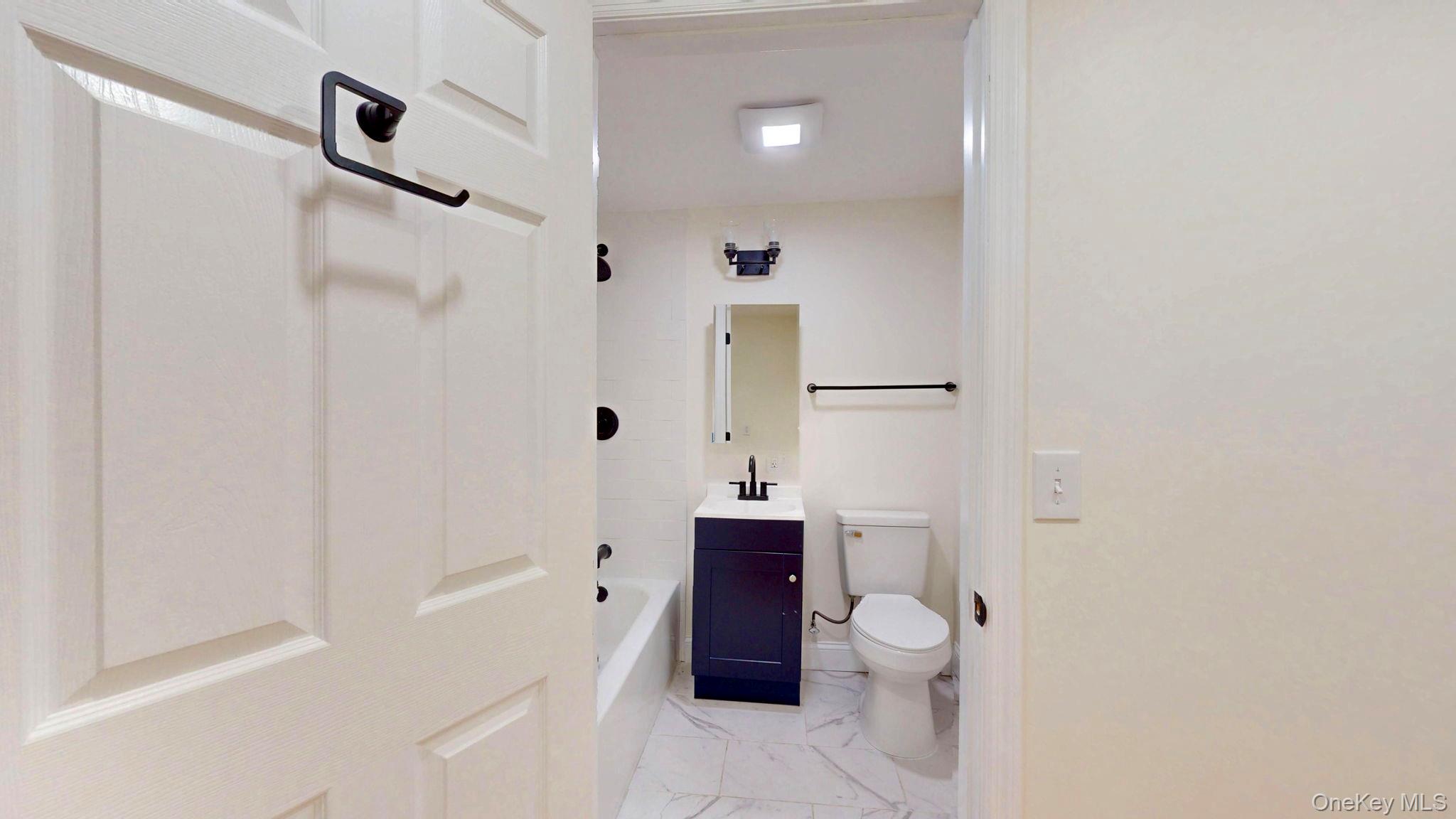 548 Dosen Road Middletown, NY 10940 - Photo 23 of 41 Bathroom with vanity, light marble finish floors, and a bathtub