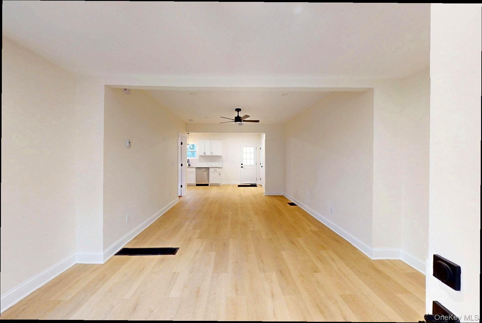 548 Dosen Road Middletown, NY 10940 - Photo 8 of 41 Unfurnished living room featuring light wood finished floors and a ceiling fan