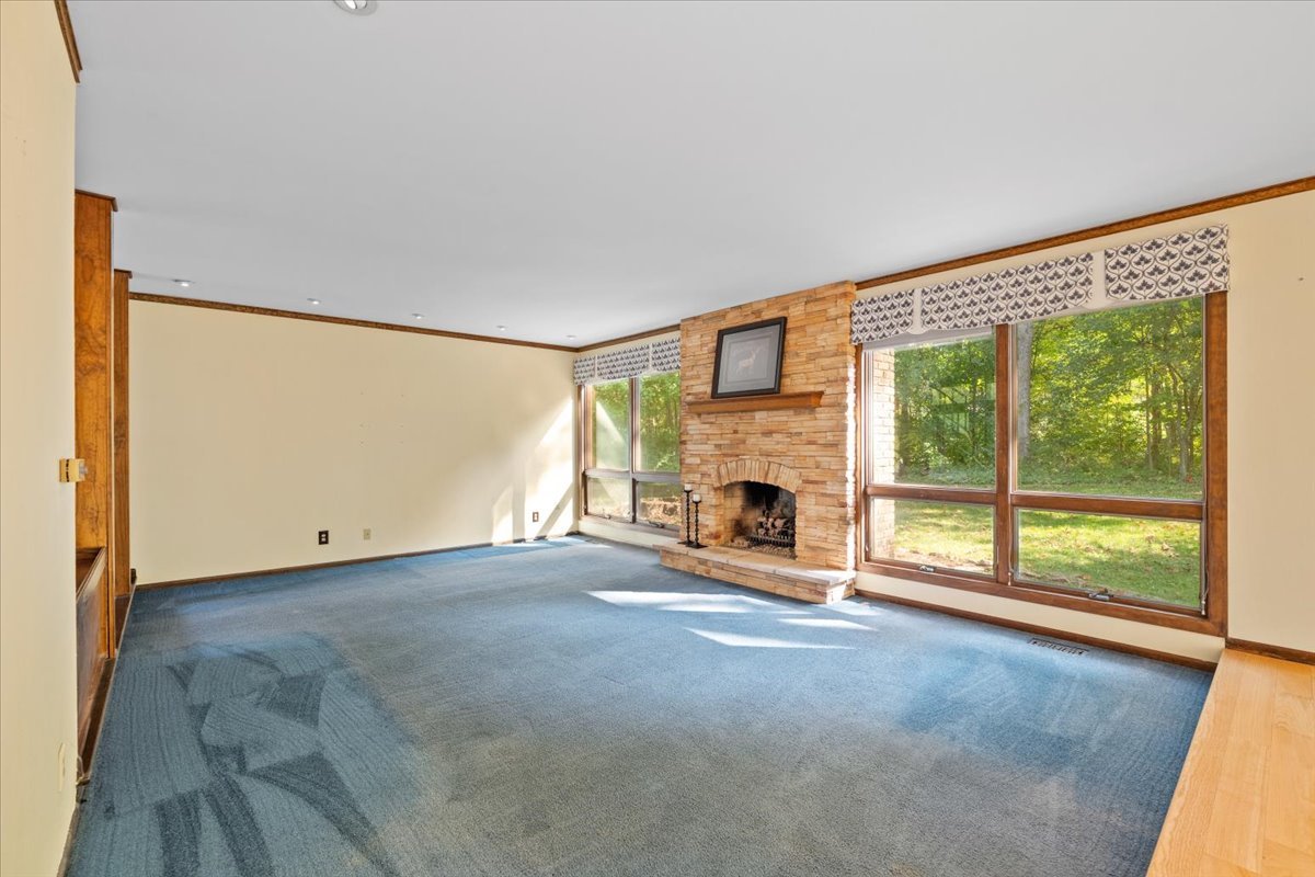 5N380 Ronsu Lane St. Charles, IL 60175 - Photo 10 of 48 a view of a livingroom with a fireplace a ceiling fan and a large window