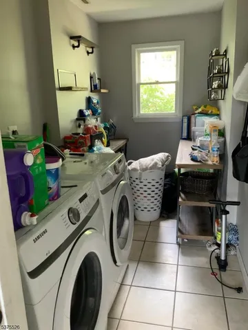 a utility room with sink dryer and washer