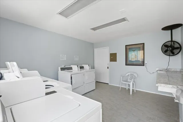 a view of a patio with a table and chairs and potted plants
