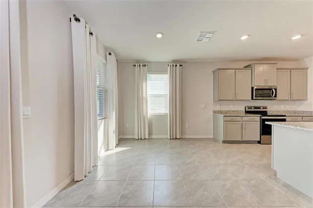 a spacious bathroom with a granite countertop sink and a mirror