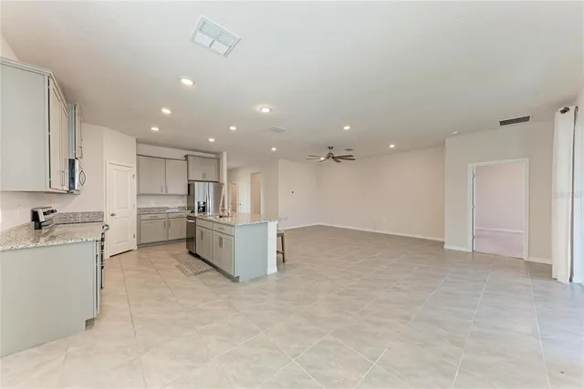 a living room with furniture and a painting on the wall