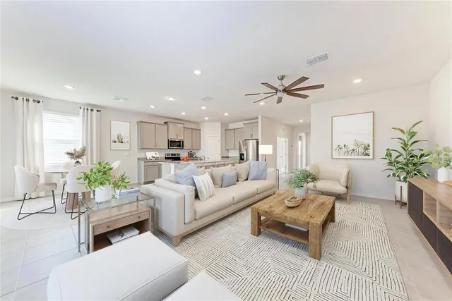 a kitchen with stainless steel appliances granite countertop a kitchen island hardwood floor and a sink