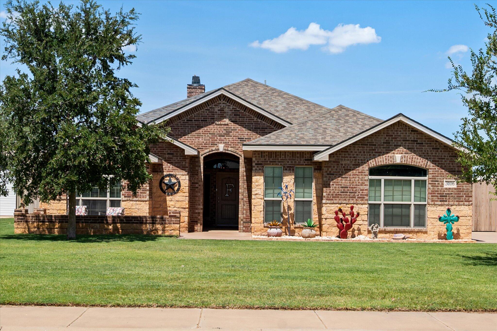 a front view of a house with a garden